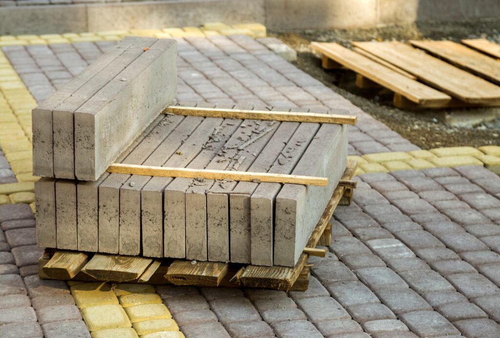 Installation of stone paving slabs in a yard.